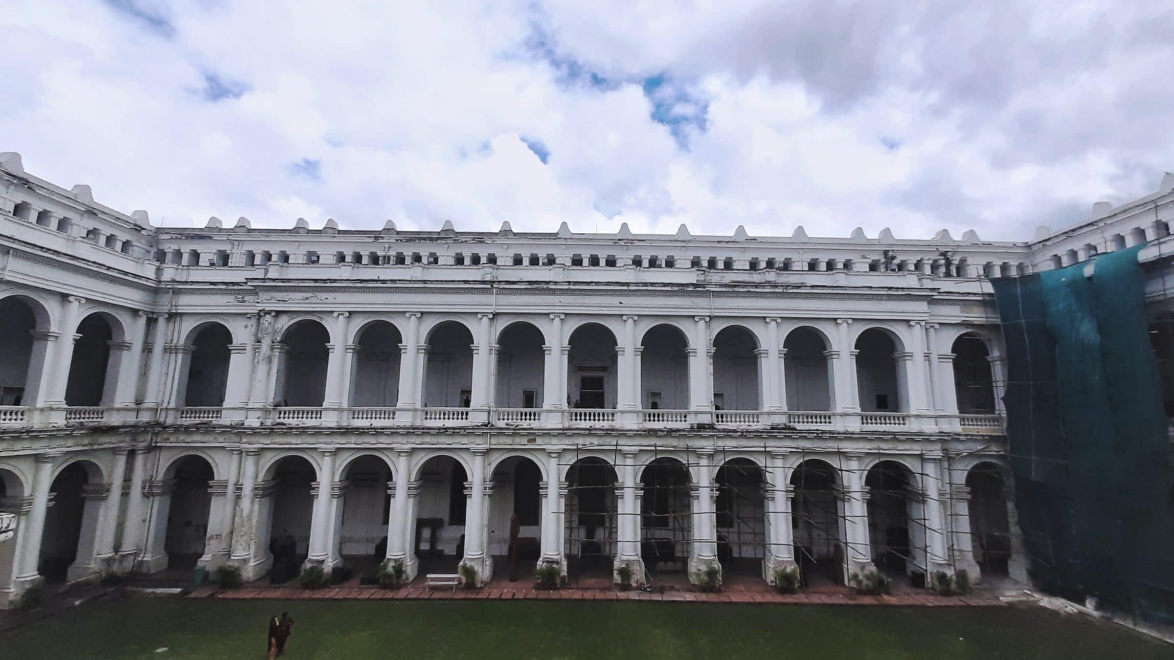 A colonnaded museum courtyard of pale stone, its arcades running the length of both storeys.